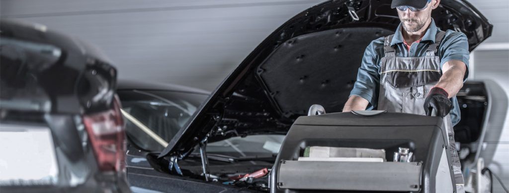 Mechanic using an air con regas machine - Car Air Conditioing Wythenshawe